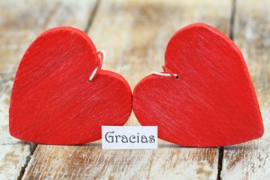 Gracias (thank you in Spanish) with two red wooden hearts