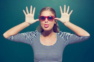 Young girl making face in front of blackboard