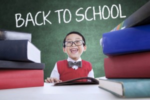 Adorable boy back to school and smiling in class