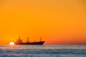 Fisherman sailling with his boat on beautiful sunrise over the sea